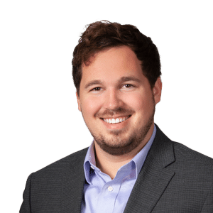 A man in a suit smiling for the camera.