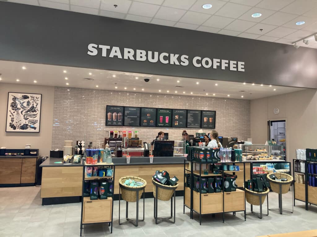 A starbucks coffee shop with a lot of products on display.