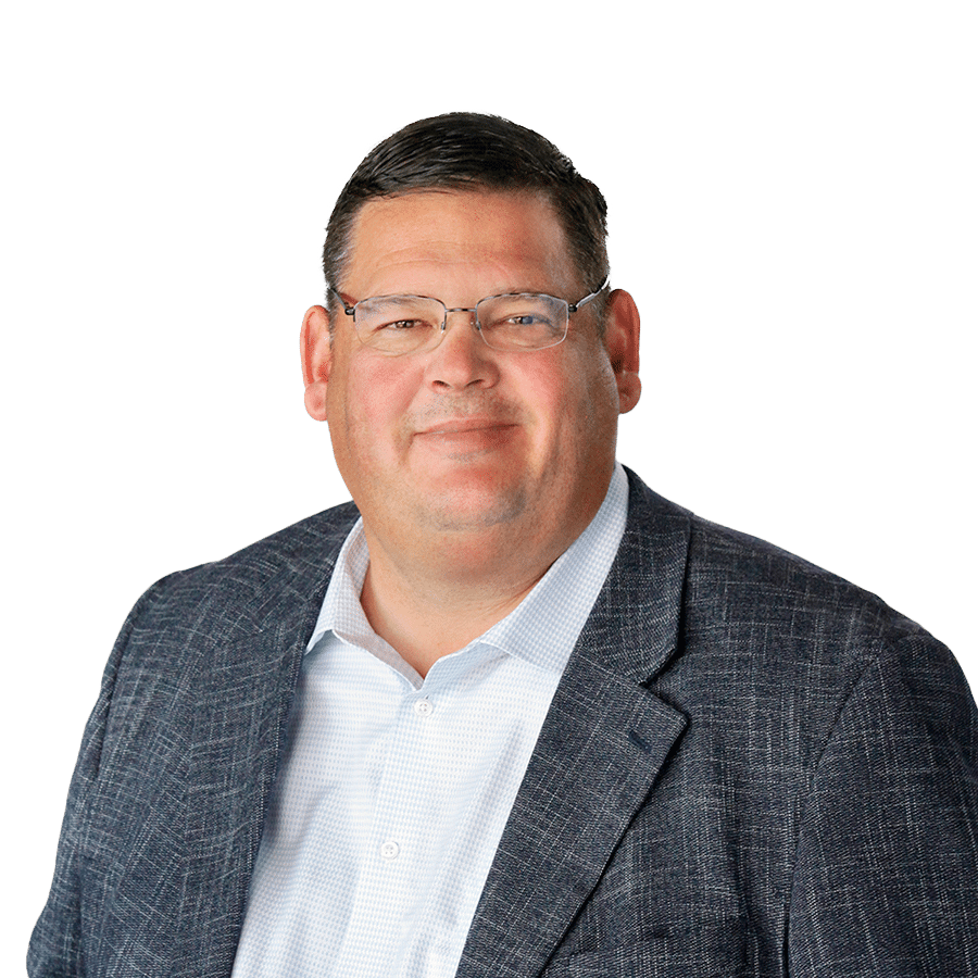 A man wearing glasses and a blazer.