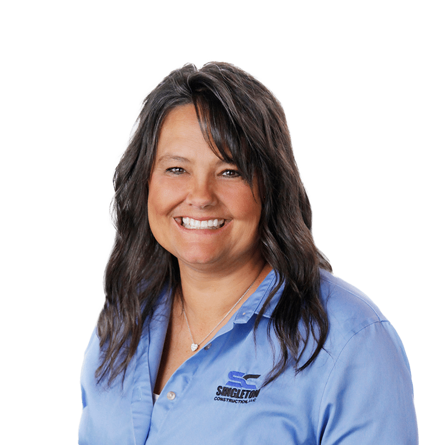A woman in a blue shirt smiling.