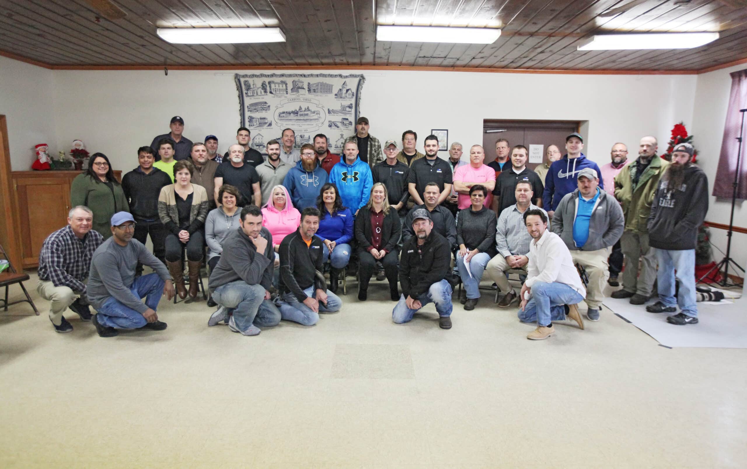 A group of people posing for a photo in a room.